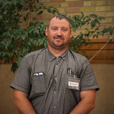 Staff member standing in an interior space
