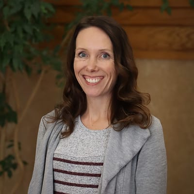 Smiling staff member in a cozy interior space