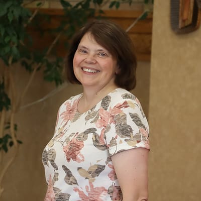 Staff member smiling in a facility interior