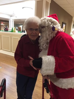 Resident with Santa during a holiday celebration