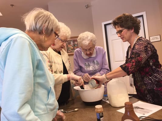 Residents and staff engaging in a cooking activity