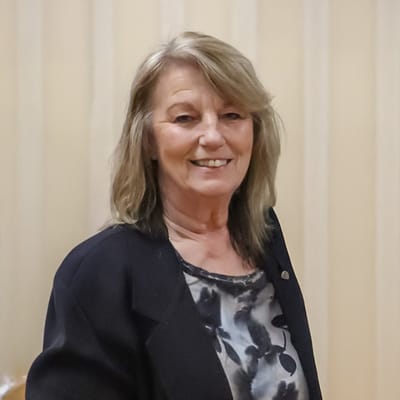 A resident smiling in a communal area