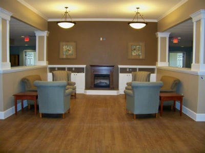 Bright common area with seating and a fireplace