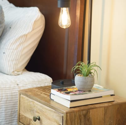 Cozy bedside table with a lamp and plant