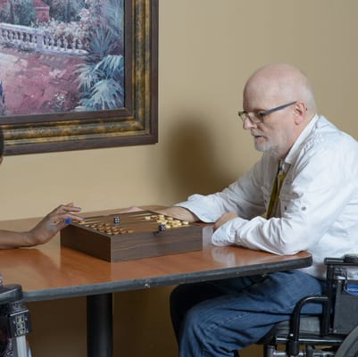 Residents engaged in a game at a table