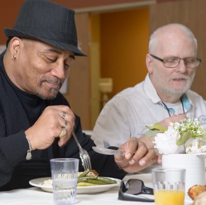 Residents enjoying a meal together in the dining room