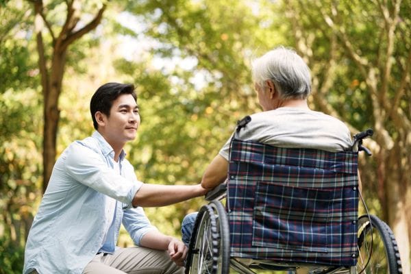 A caregiver interacting with a resident in a garden