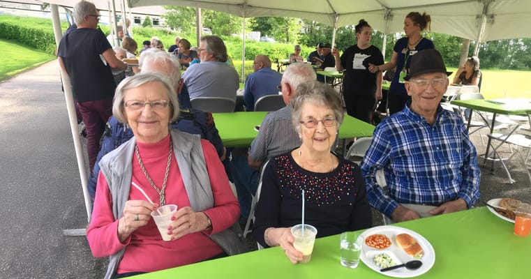 Residents enjoying a meal in an outdoor dining setting
