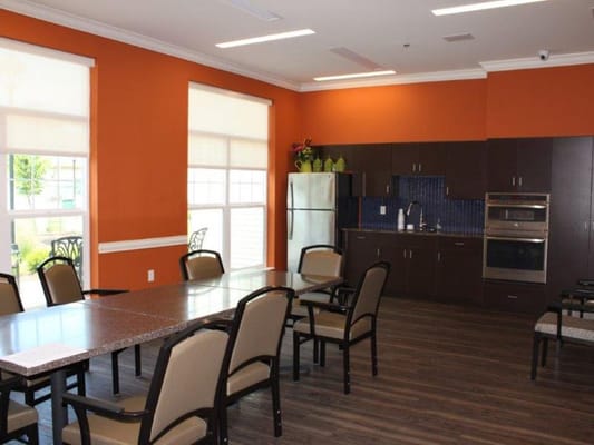 Bright common area with a large table and chairs
