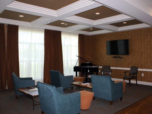 Cozy common area with seating and a piano
