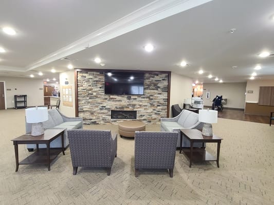 Common area with seating and decorative fireplace