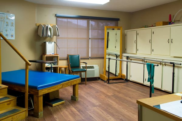 Rehabilitation room with therapy equipment and furniture