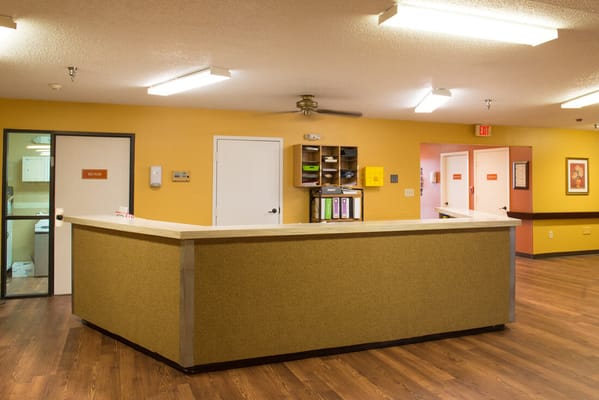 Bright reception area with yellow walls and wooden flooring