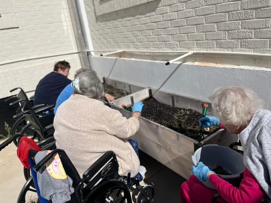 Residents gardening in outdoor planters