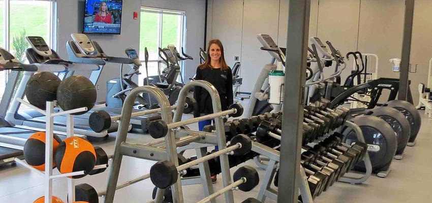 A fitness area in the facility with exercise equipment and staff