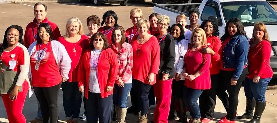 Staff members posing together outside the facility