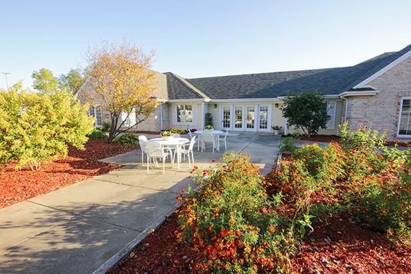 Outdoor space with tables and flowers at Brookdale Meridian