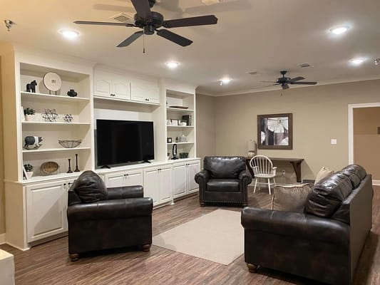 Cozy common area with seating and entertainment unit
