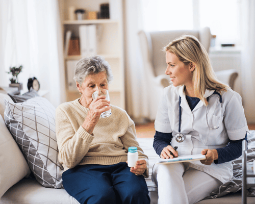 A caregiver assisting a resident with medication