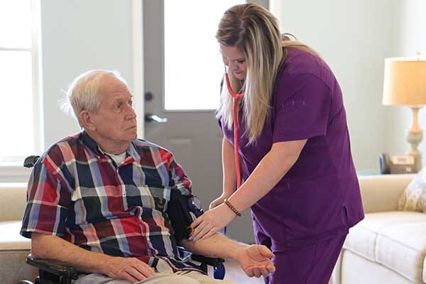 Caregiver assisting a resident in a common area