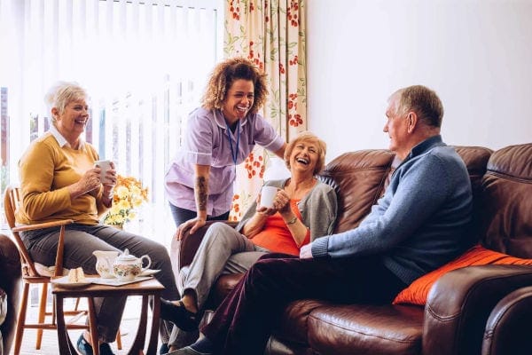 Residents enjoying conversation in a cozy living room