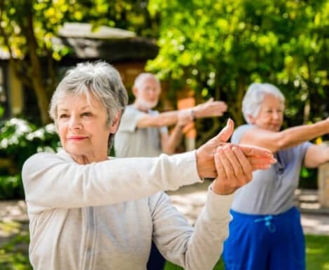 Residents participating in a stretching activity outdoors