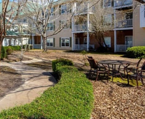 Garden area with seating and pathways in a senior living facility