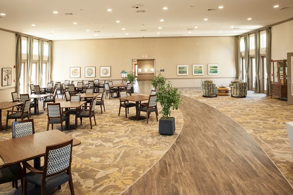 Bright and inviting common area with tables and seating