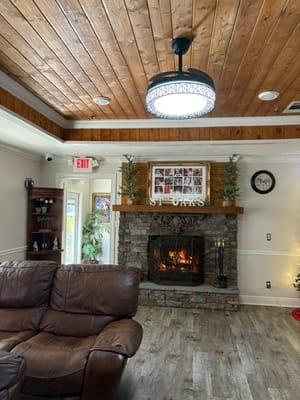 Cozy lounge area with fireplace in St. Oaks Care Center