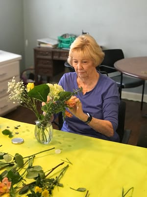 Resident arranging flowers during an activity session
