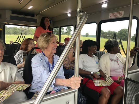 Residents enjoying a bus outing with staff