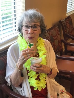 Resident enjoying a drink at a festive gathering