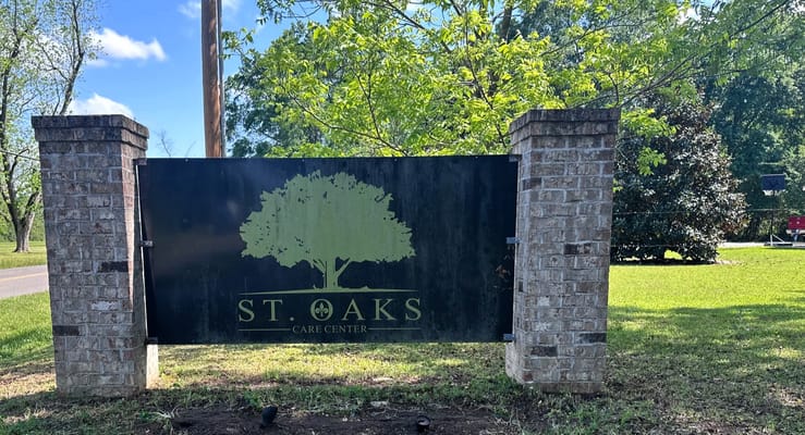 Sign for St. Oaks Care Center in a green space