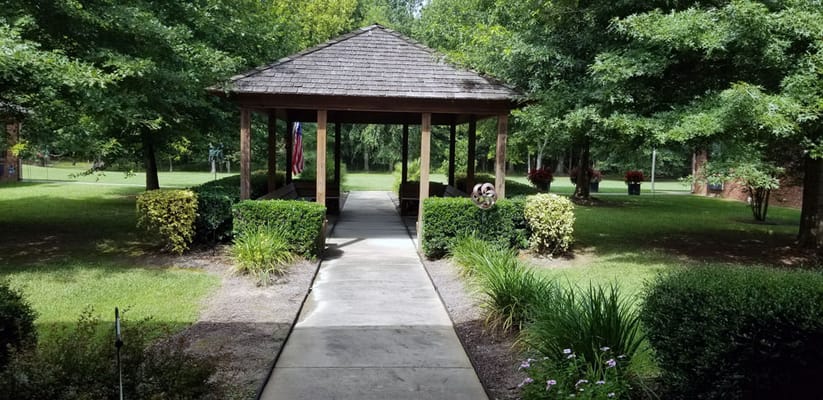 Pathway leading to a gazebo in a garden