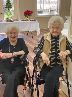 Two residents smiling in a common area