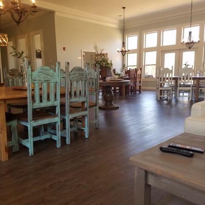 Interior view of a common area with wooden tables and chairs