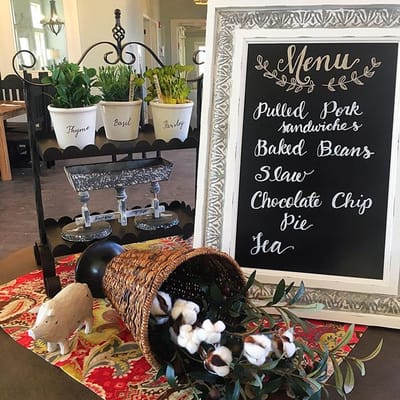 Menu display in a dining area with plants