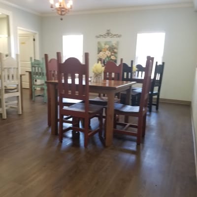 A cozy dining area with colorful chairs and wooden tables