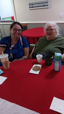 Residents enjoying cookies and drinks at a table