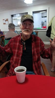 A resident enjoying a drink in a common area