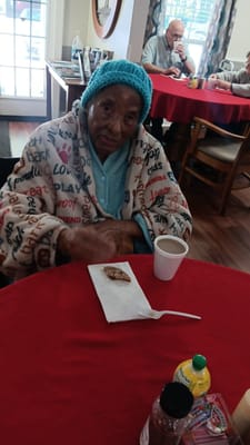 Resident enjoying dessert in a dining area
