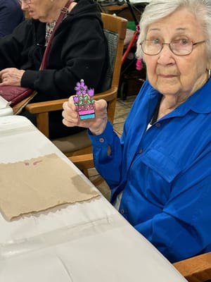 Resident enjoying a craft activity at a table