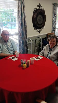 Two residents enjoying dessert at a table