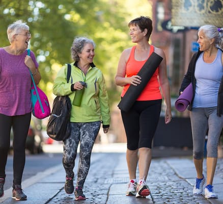 Four women enjoying a walk outdoors in active wear