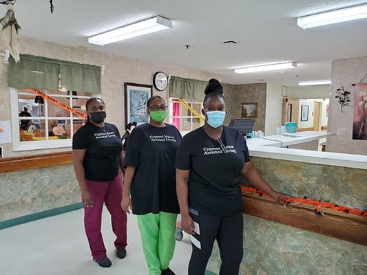 Staff members in uniforms at the facility's interior