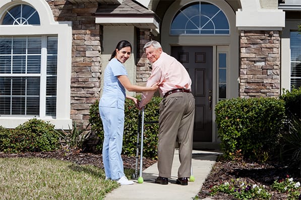 Staff assisting a resident outside the facility