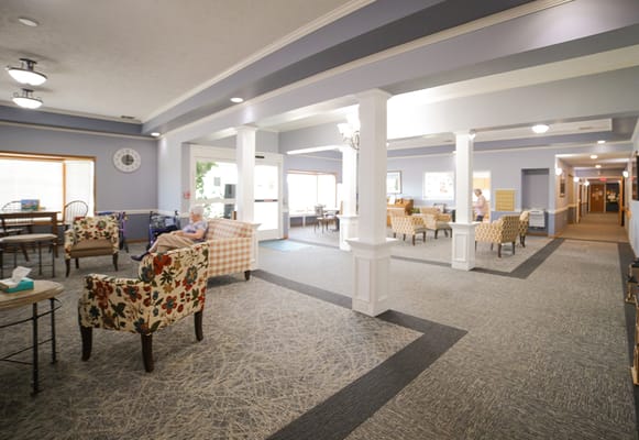 Bright common area with seating and residents