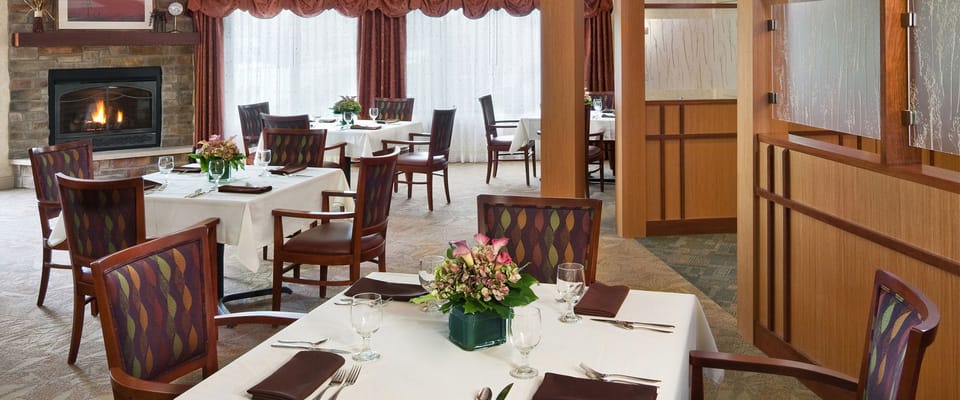 Bright dining room with tables set for meals