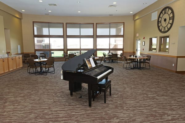 Common area with a piano and seating