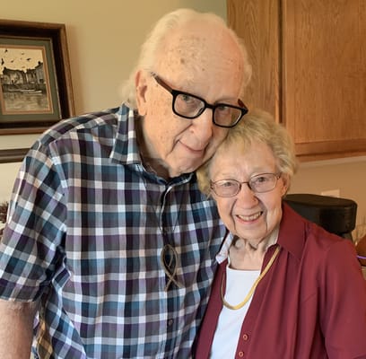 Two residents smiling together in a cozy common area